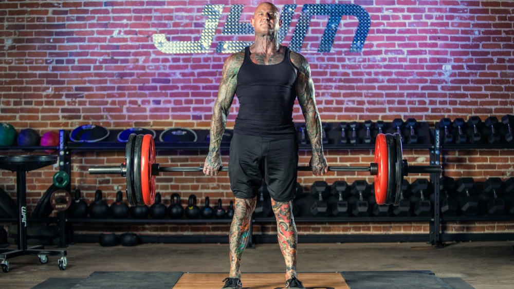 Jim Stoppani doing a barbell hack squat